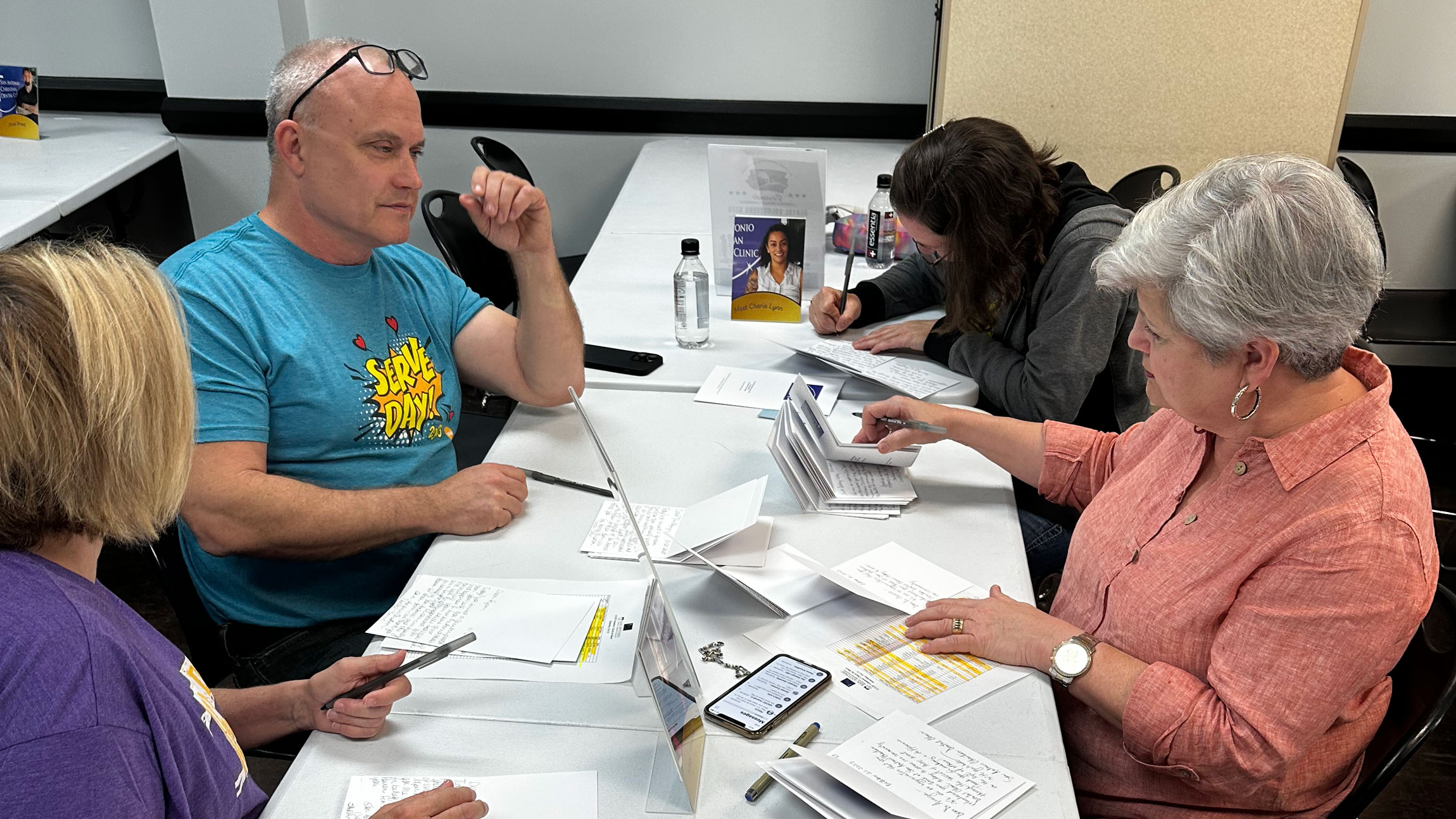 people sitting at table going over paperwork